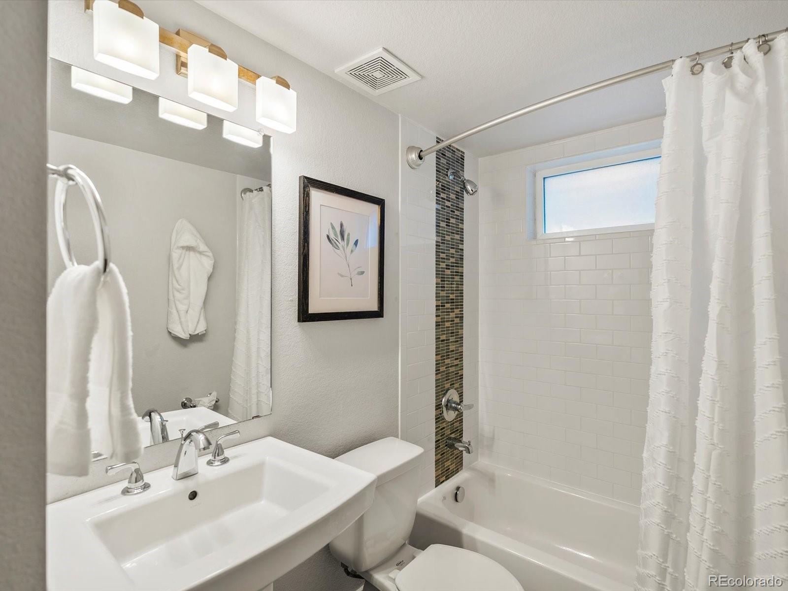 2289 Hudson Street Denver, CO 80207 - Photo 27 of 44 a bathroom with a sink toilet and shower