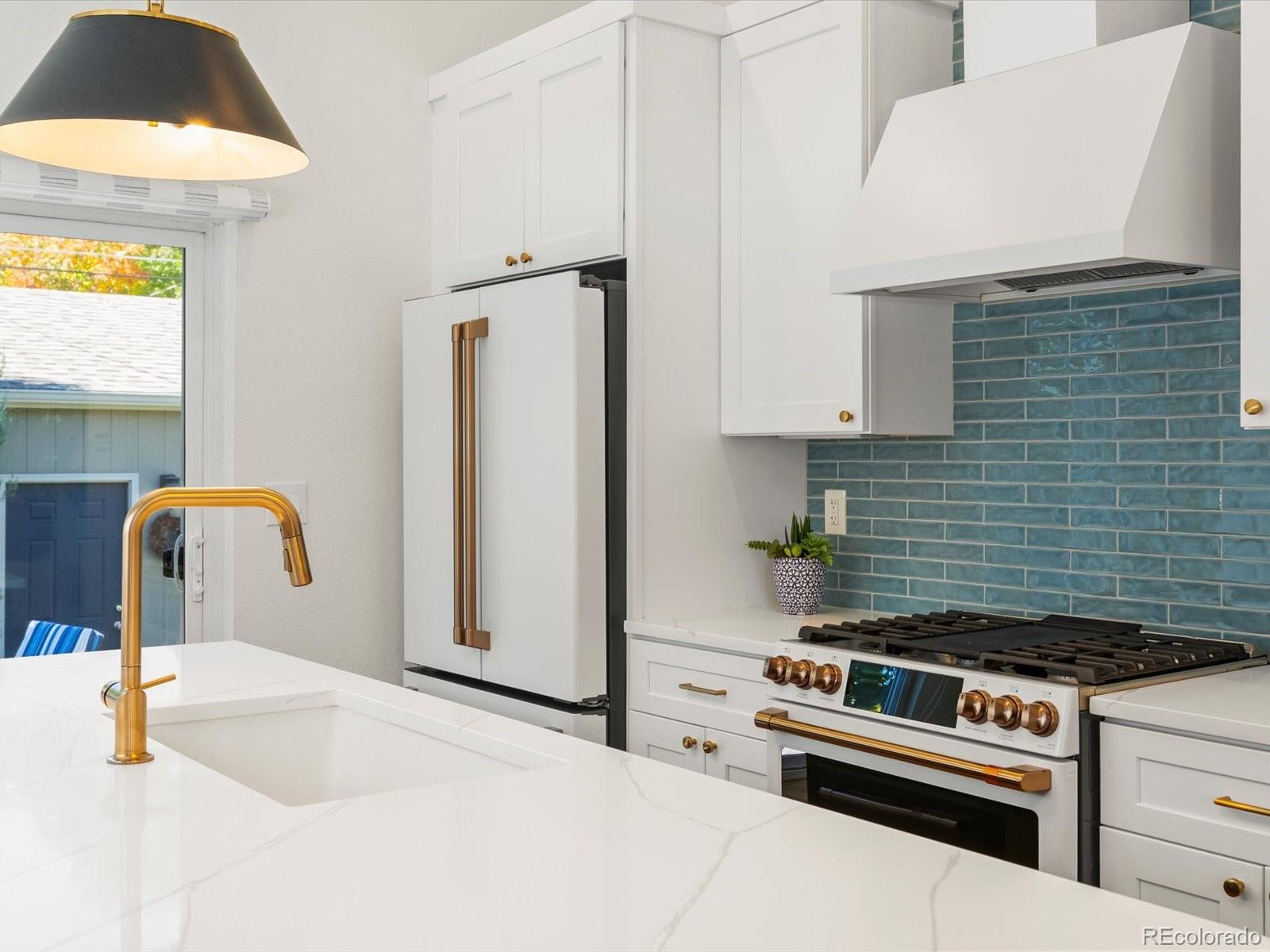 2289 Hudson Street Denver, CO 80207 - Photo 9 of 44 a kitchen with a stove and a refrigerator