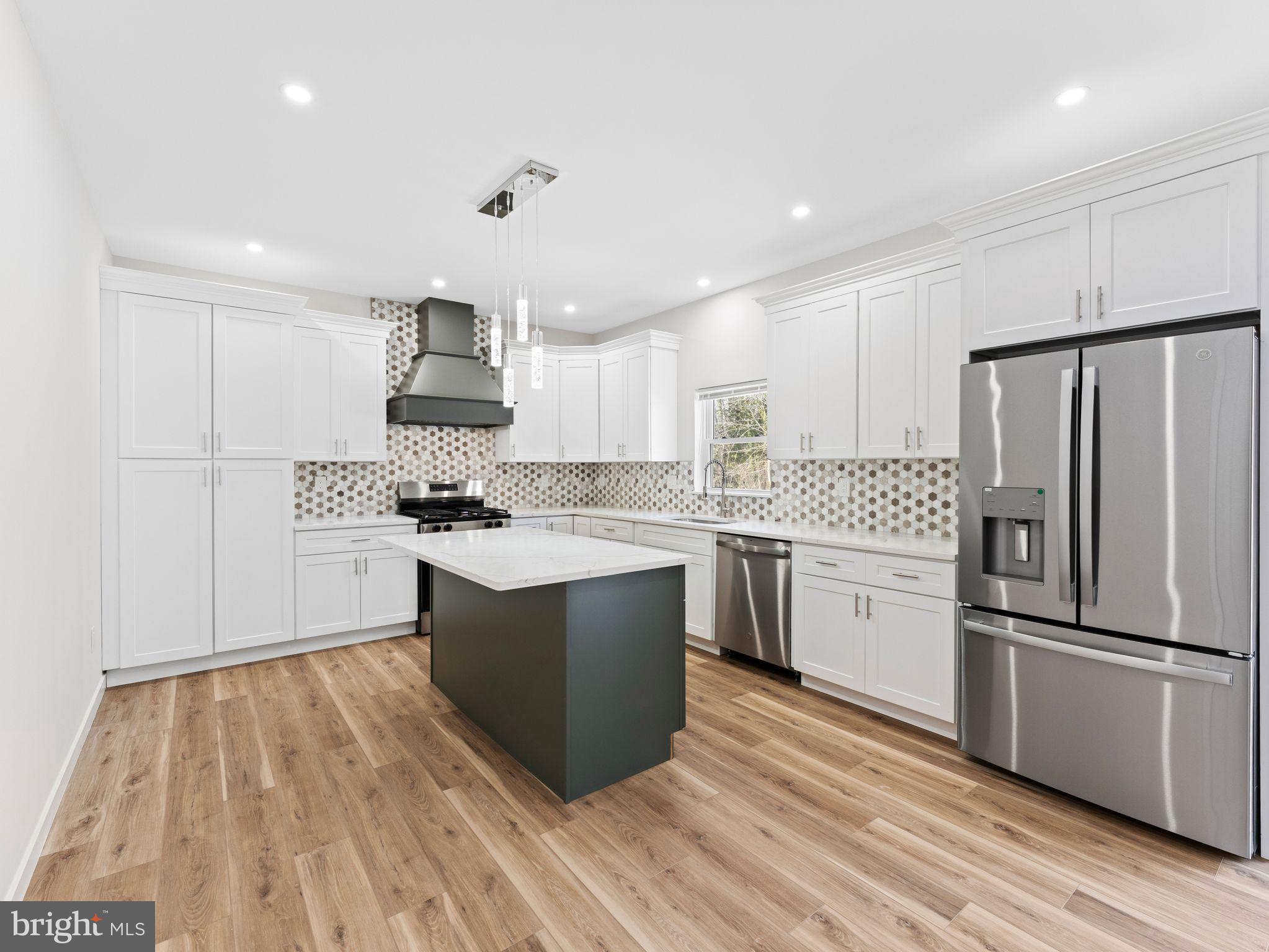 a kitchen with a refrigerator and a sink
