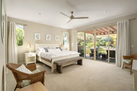 a spacious bedroom with a bed and a large window
