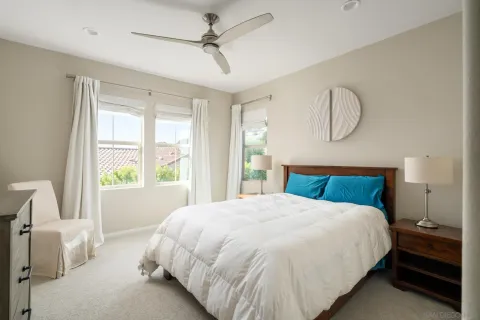 a bedroom with a large bed and a window