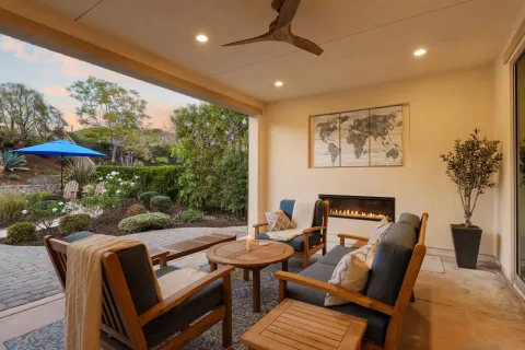 a view of backyard with a table and chairs and potted plants