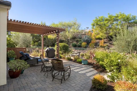 a view of a house with sitting area and garden