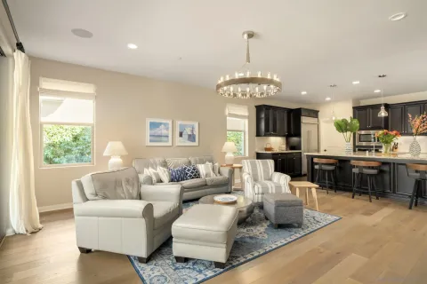 a living room with furniture kitchen and a chandelier