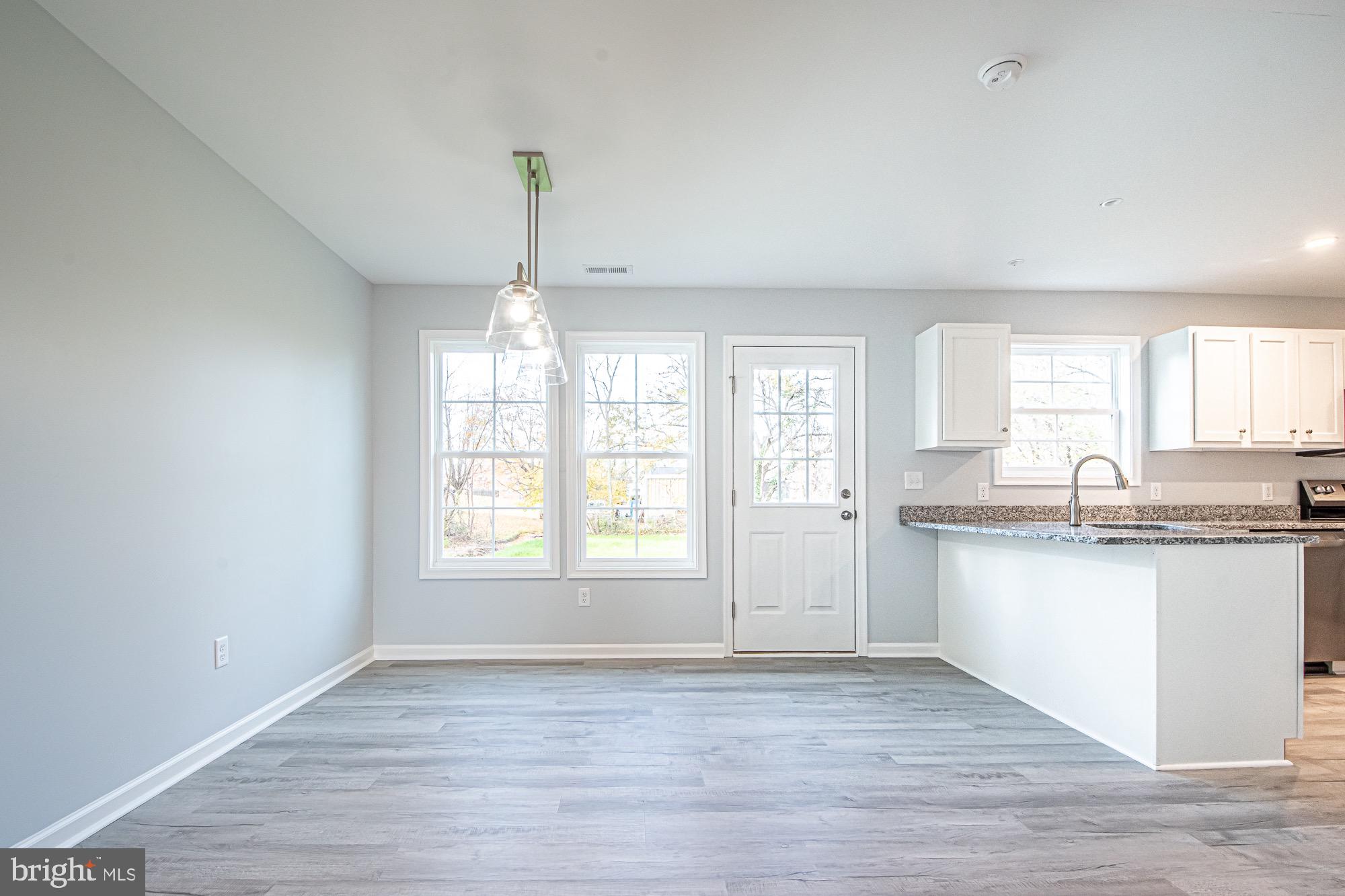 709 Ross Street Winchester, VA 22601 - Photo 17 of 40 a view of a kitchen with a sink dishwasher and wooden floor