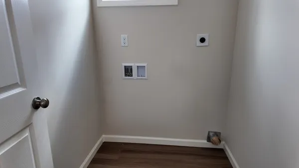an empty room with ceiling fan and window