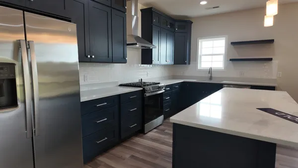 a kitchen with stainless steel appliances a sink stove and refrigerator