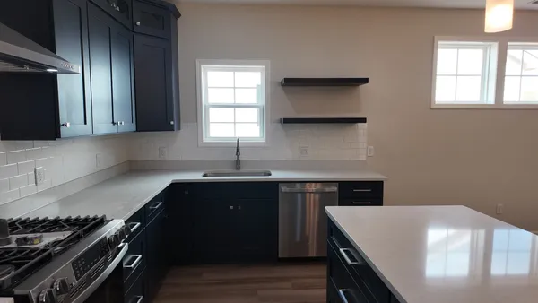 a kitchen with a sink and a stove top oven