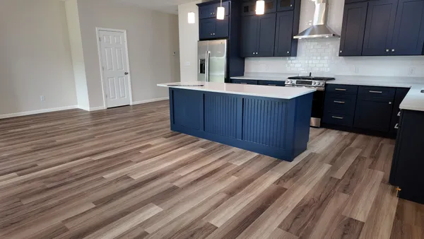 a kitchen with stainless steel appliances granite countertop a sink stove and wooden cabinets