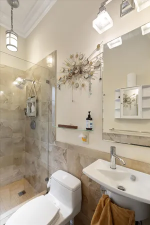 a bathroom with a sink a toilet and shower