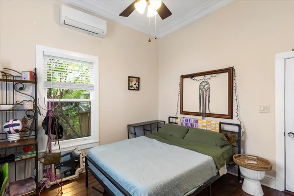 a bedroom with a bed and a window
