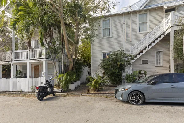 a front view of a house with parking space