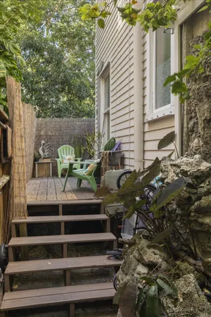 a view of building with bench and potted plants
