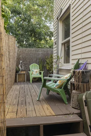 a view of a patio with couches table and chairs and potted plants