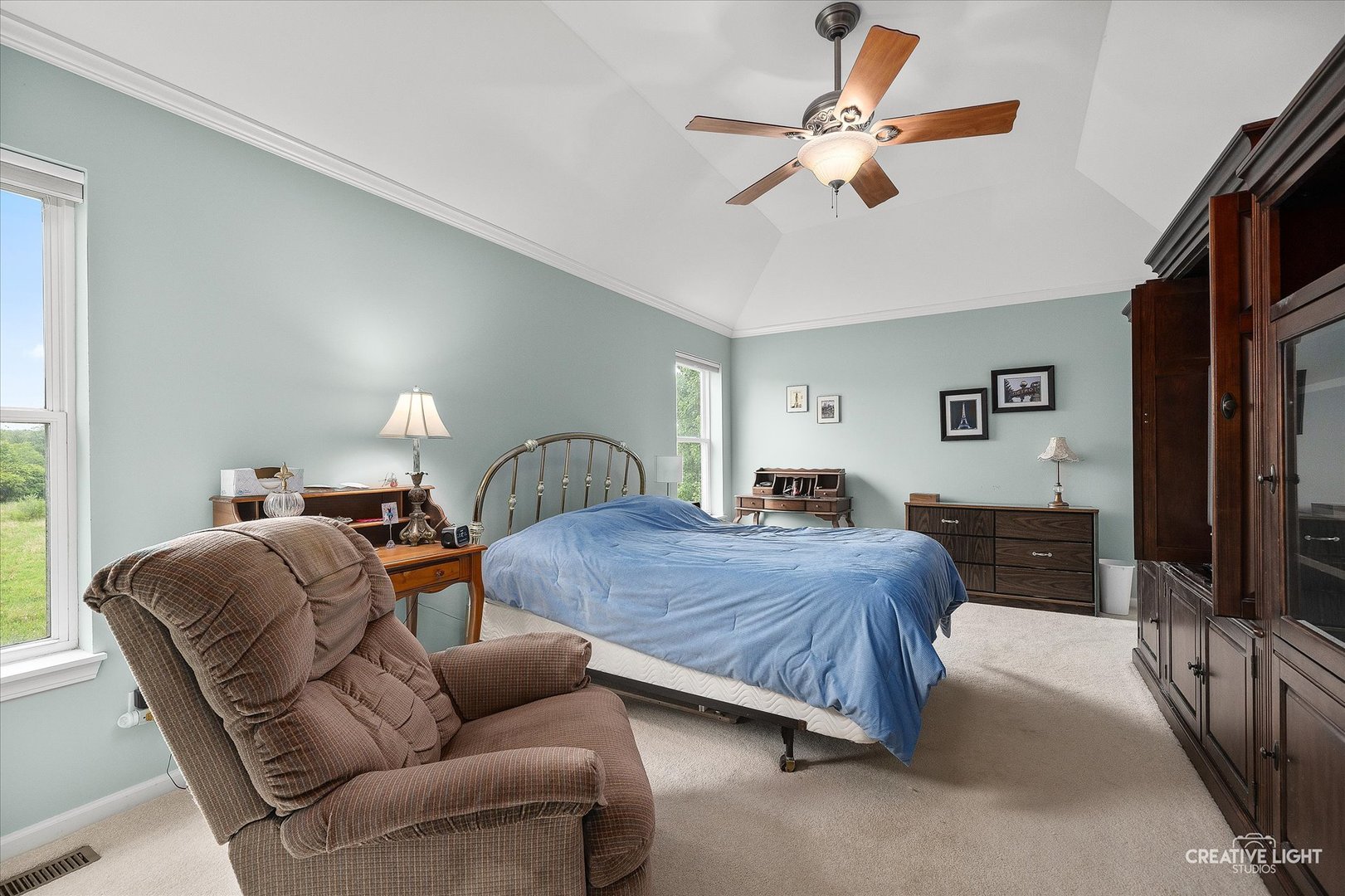 S970 Newton Square Geneva, IL 60134 - Photo 14 of 35 a spacious bedroom with a bed a couch and a chandelier
