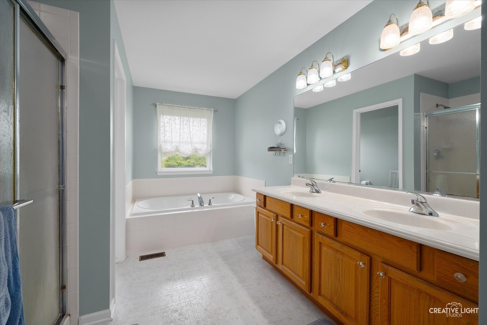 S970 Newton Square Geneva, IL 60134 - Photo 16 of 35 a spacious bathroom with a tub double sink large mirror and vanity