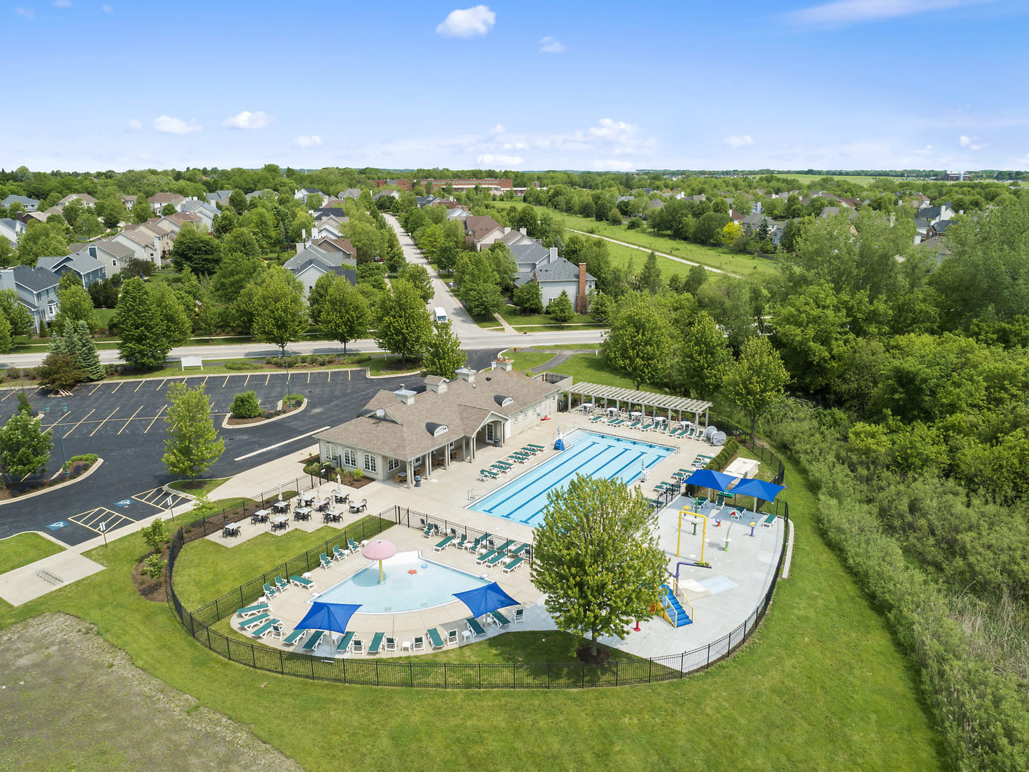 S970 Newton Square Geneva, IL 60134 - Photo 31 of 35 a view of a swimming pool in he middle of the green field