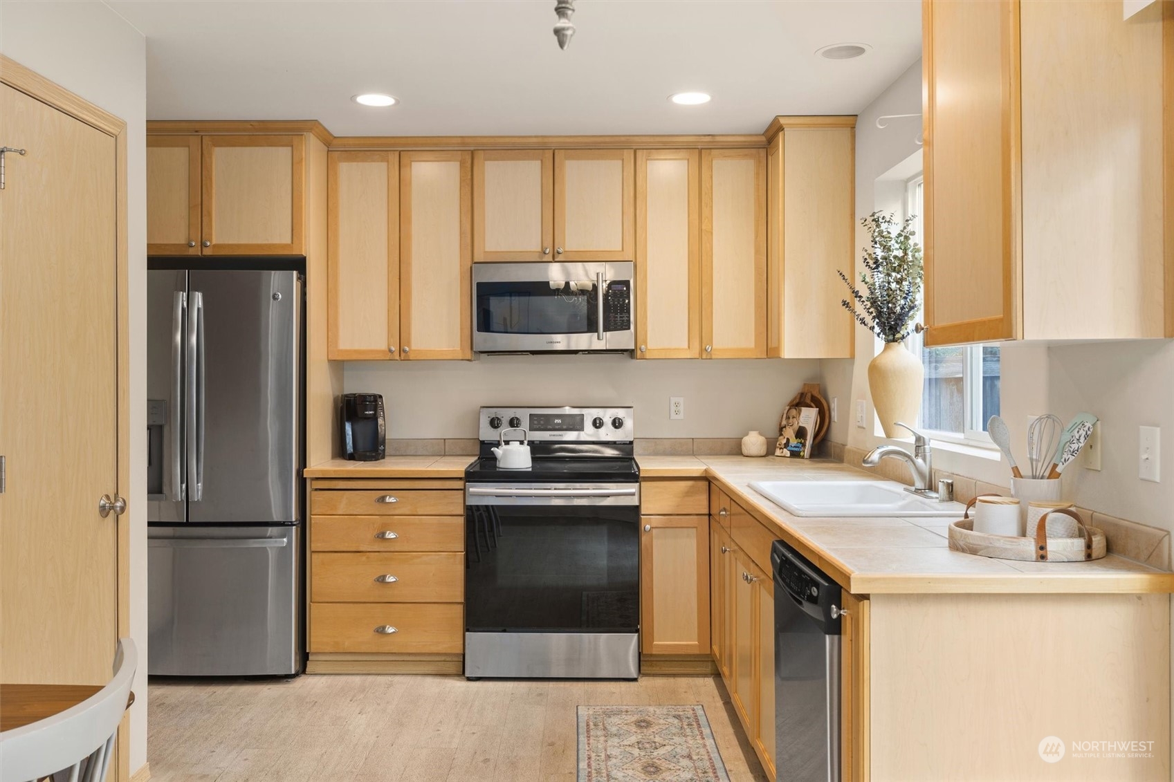 2430 194th Street Southeast Bothell, WA 98012 - Photo 8 of 27 a kitchen with a stove a sink and a microwave