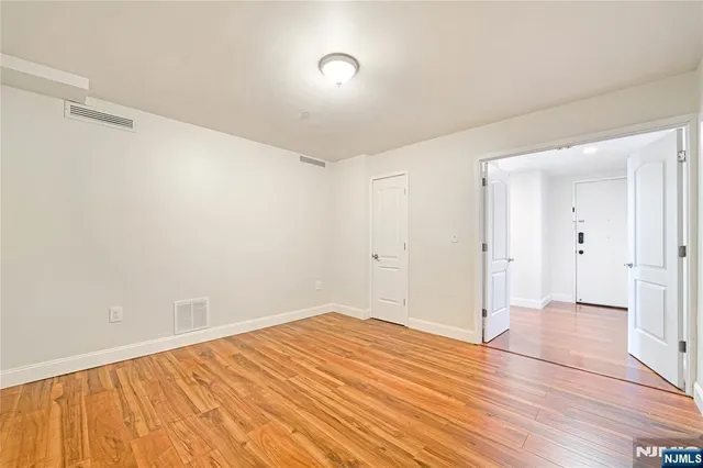 a view of a room with wooden floor and bathroom