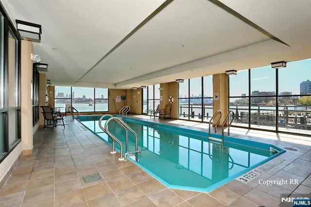 a view of a swimming pool with outdoor seating