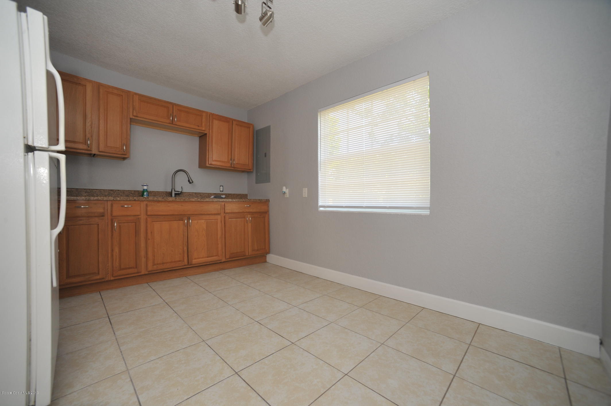 1049 Mitchell Street Cocoa, FL 32922 - Photo 5 of 12 a view of a kitchen with two sink and a window