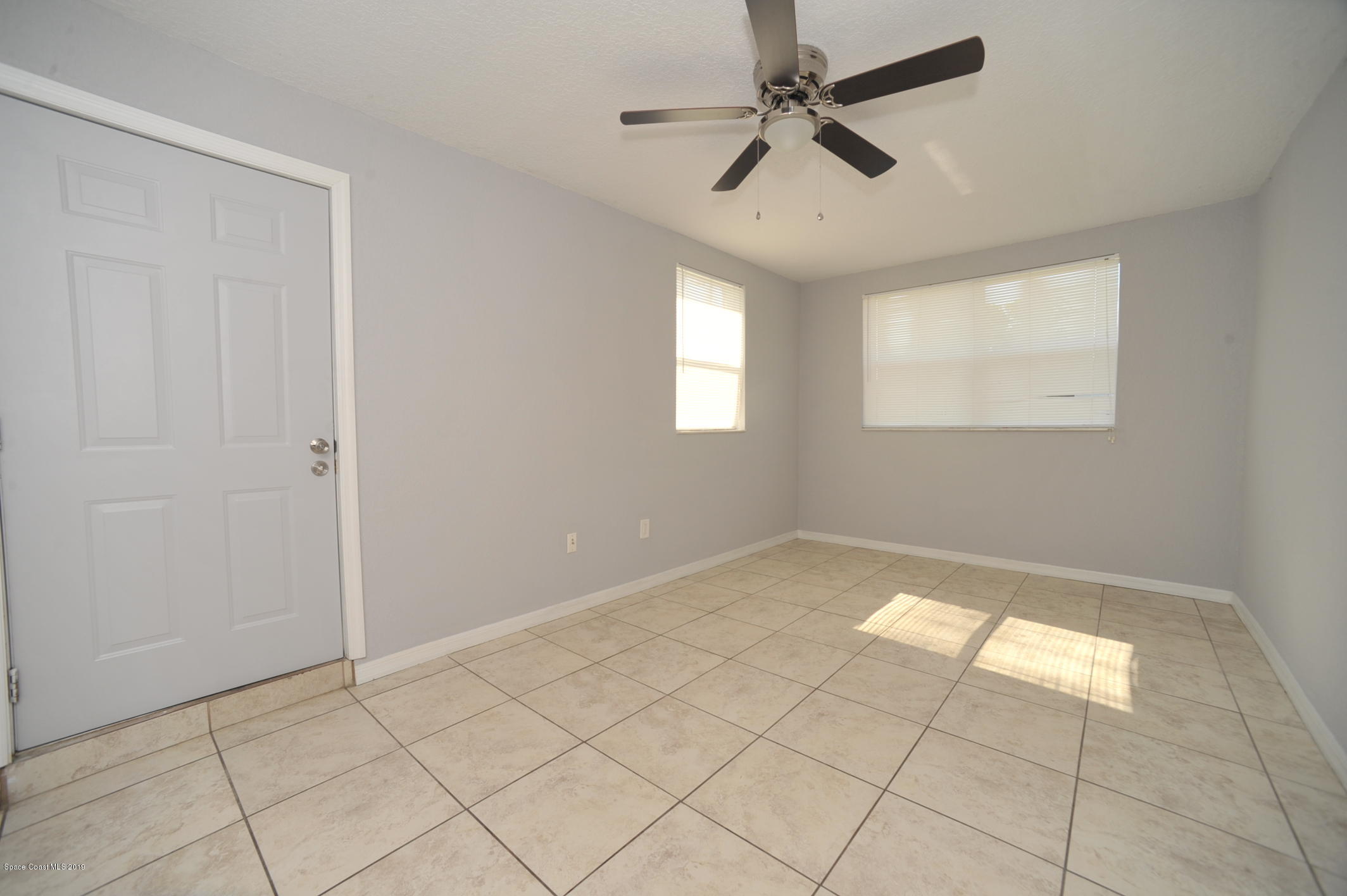 1049 Mitchell Street Cocoa, FL 32922 - Photo 6 of 12 a view of an empty room and window