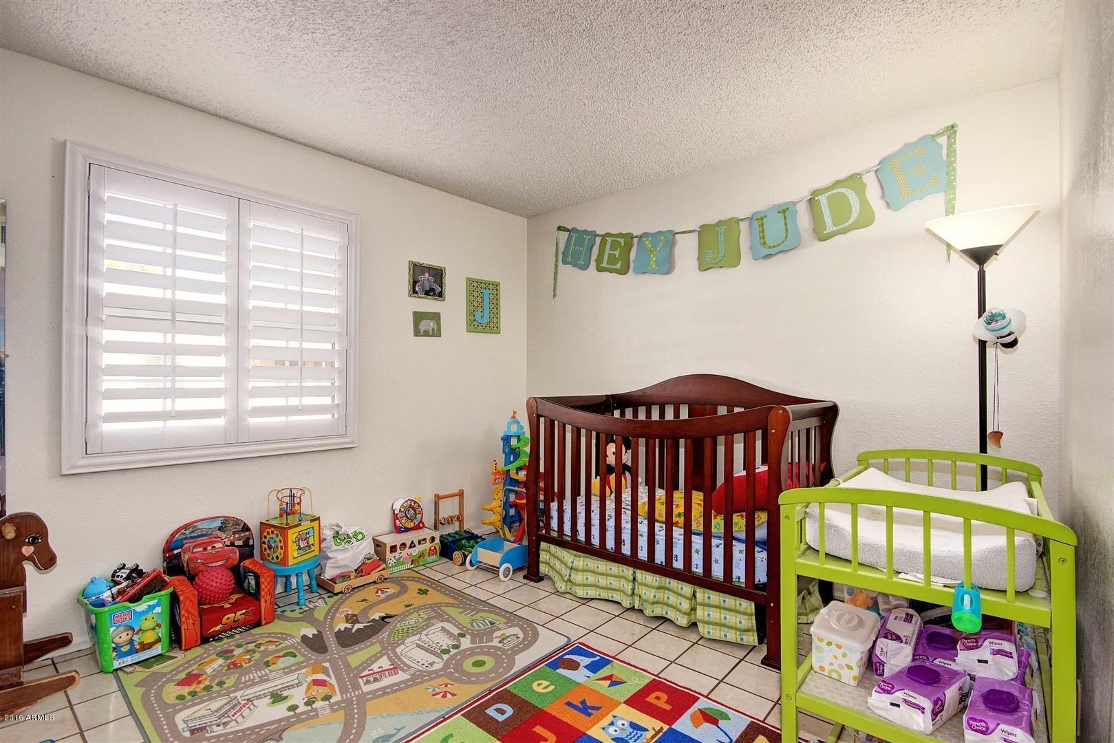 2929 East Broadway Road, Unit 102 Mesa, AZ 85204 - Photo 11 of 16 a bedroom with a bed and window