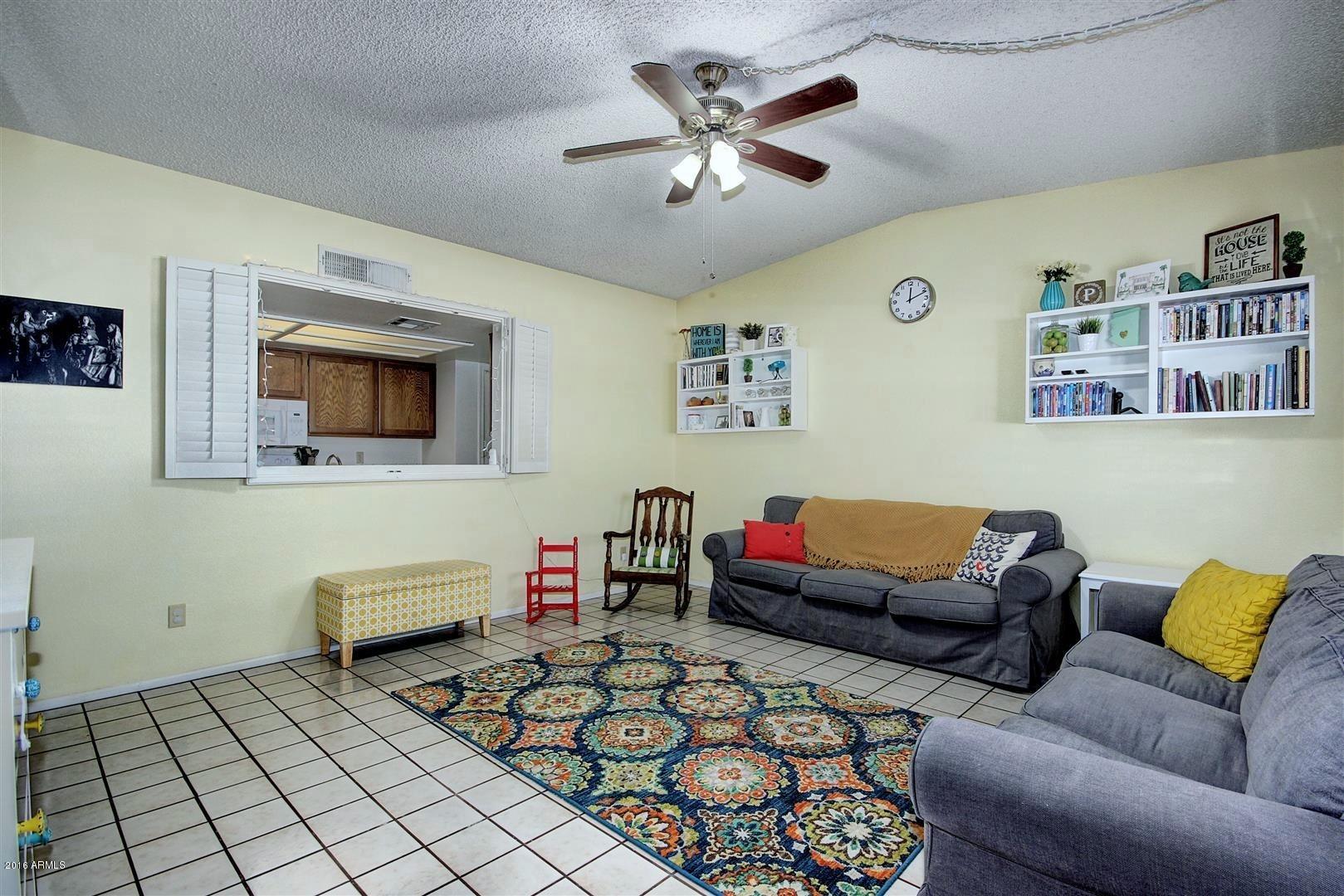 2929 East Broadway Road, Unit 102 Mesa, AZ 85204 - Photo 3 of 16 a living room with furniture and a rug