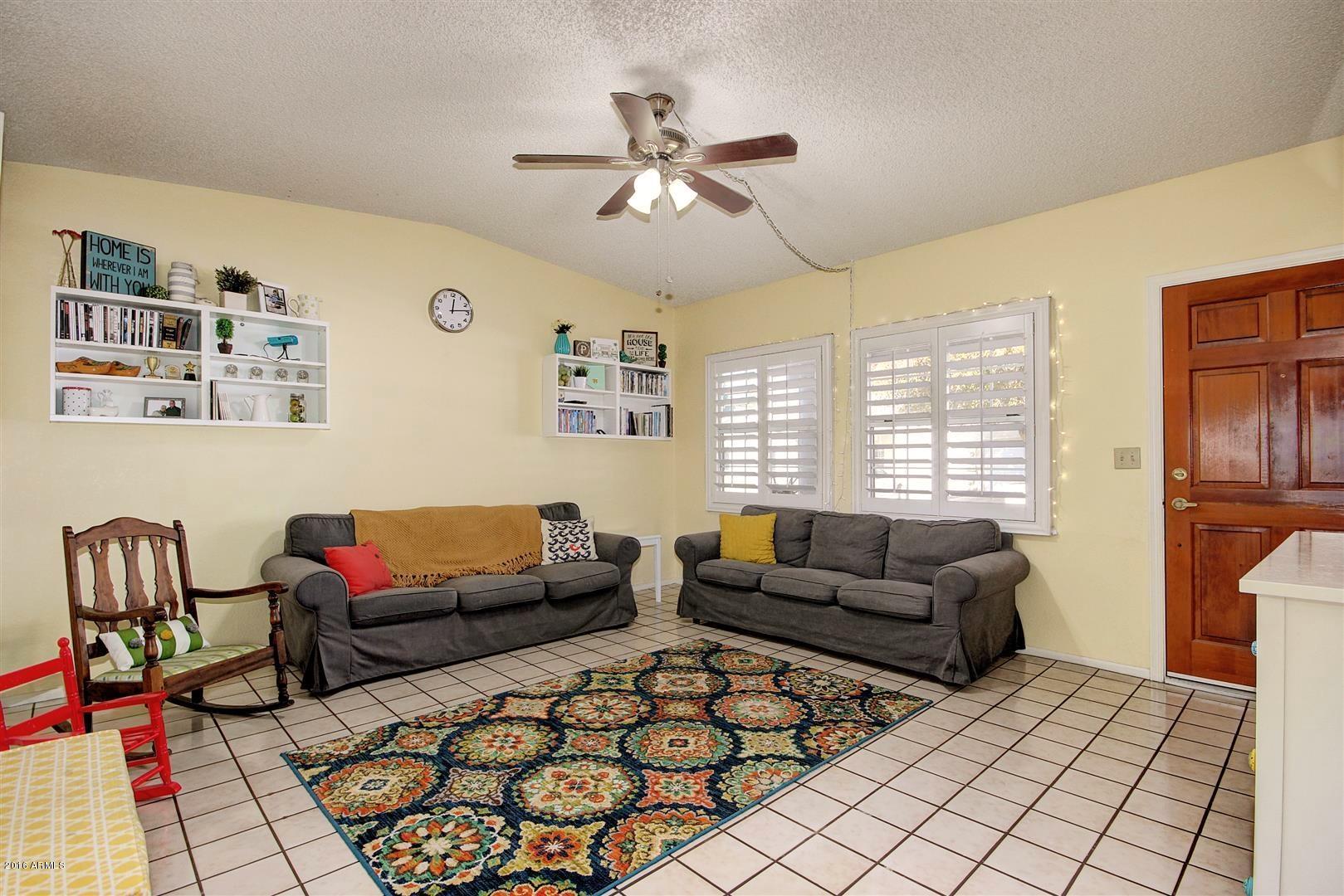 2929 East Broadway Road, Unit 102 Mesa, AZ 85204 - Photo 4 of 16 a living room with furniture and a window