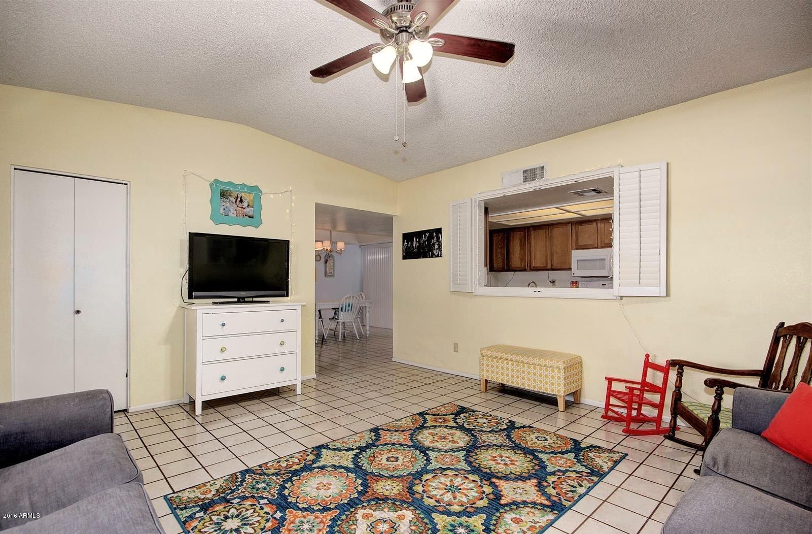 2929 East Broadway Road, Unit 102 Mesa, AZ 85204 - Photo 5 of 16 a living room with furniture and a flat screen tv