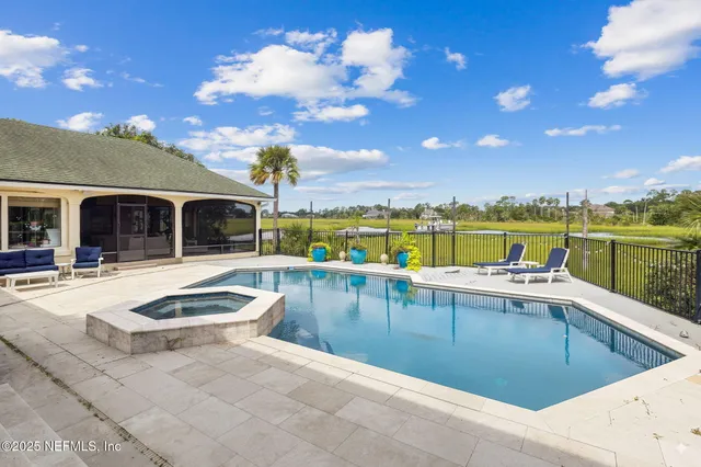 a living room with furniture and floor to ceiling windows