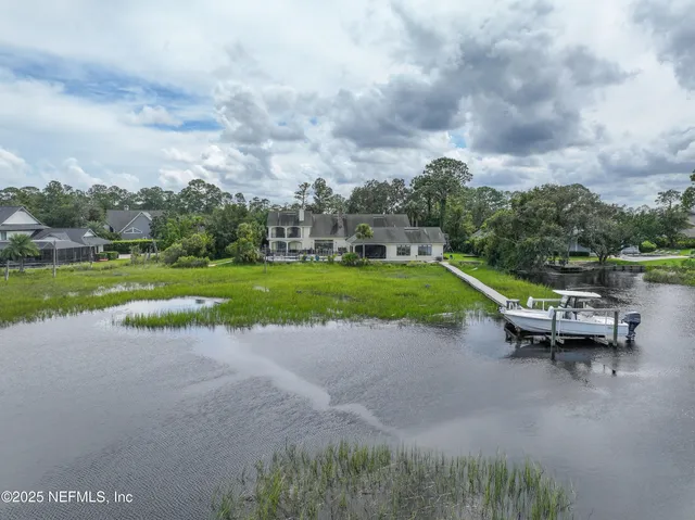 a view of a swimming pool with outdoor seating and city view