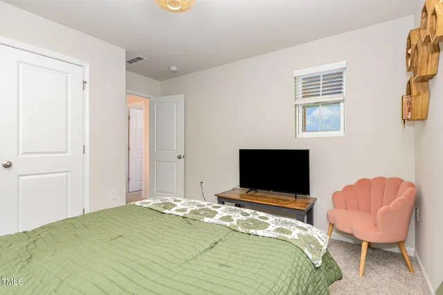 a bedroom with a bed and a window