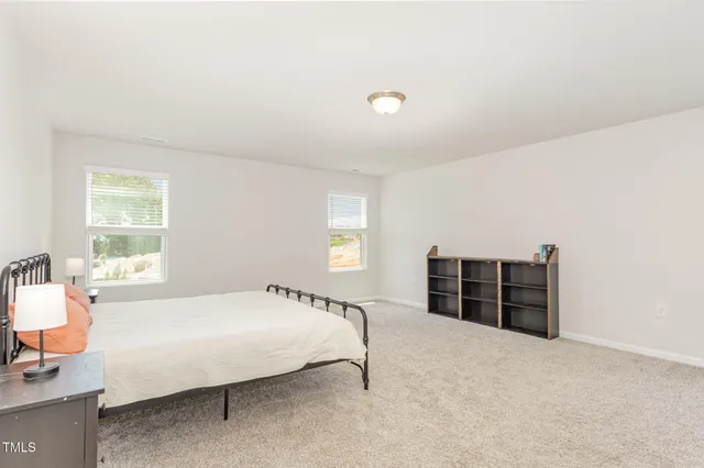 a spacious bedroom with a bed and a couch