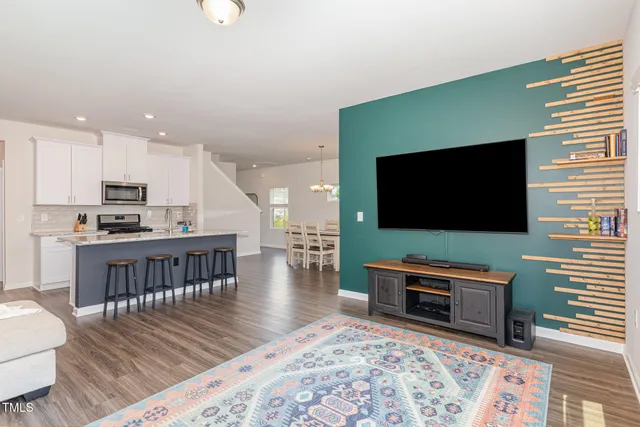 a living room with furniture and view of kitchen