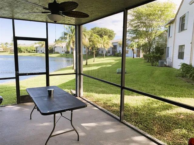 a balcony view with a couple of chairs and a table