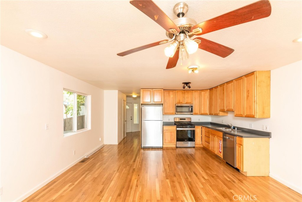 4567 State Highway 20 Nice, CA 95464 - Photo 41 of 58 a kitchen with stainless steel appliances a stove a sink and white cabinets with wooden floor