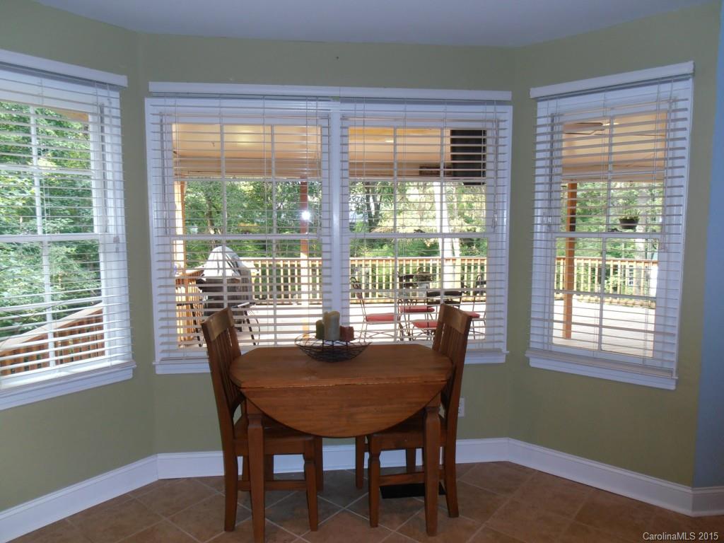 11031 Painted Tree Road Charlotte, NC 28226 - Photo 5 of 15 a dining room with furniture a rug and a large window