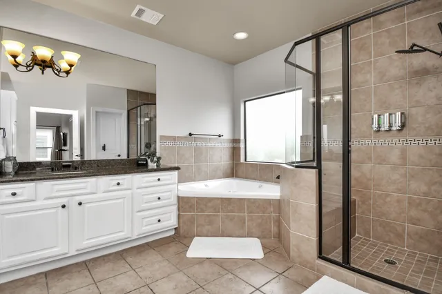 a kitchen with stainless steel appliances granite countertop a stove a sink dishwasher a refrigerator and a microwave with wooden floor