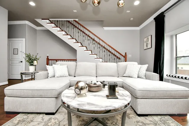 a kitchen with stainless steel appliances granite countertop a refrigerator a sink dishwasher a stove and white cabinets with wooden floor