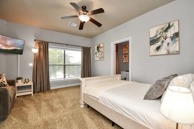 a bedroom with a bed and a chandelier