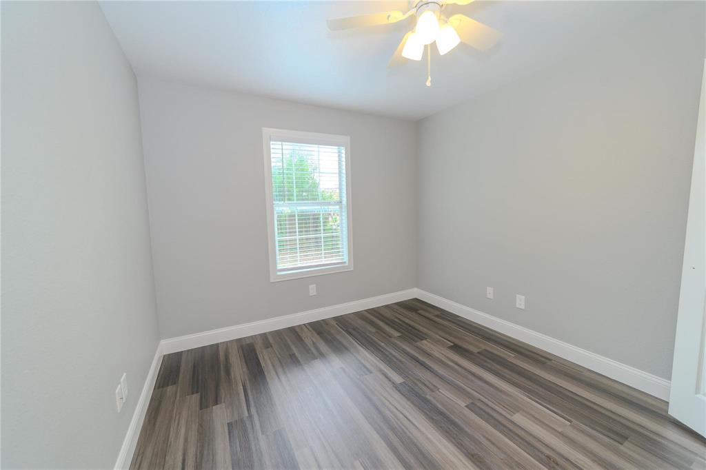 809 Wilcox Street McKinney, TX 75069 - Photo 22 of 26 Empty room with ceiling fan and dark wood-style floors