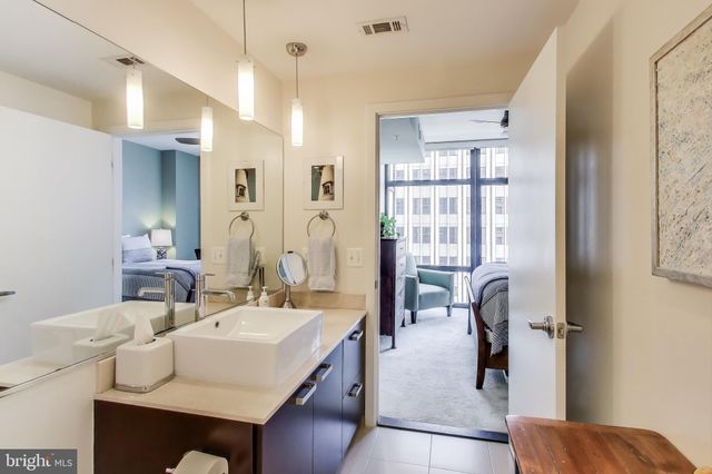 a bathroom with a sink shower and a mirror