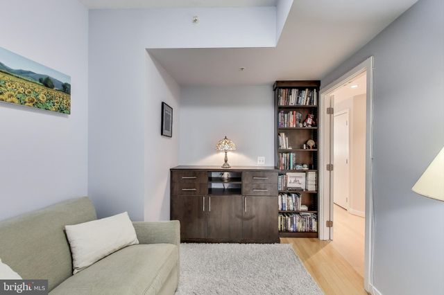 a living room with furniture a rug and a window