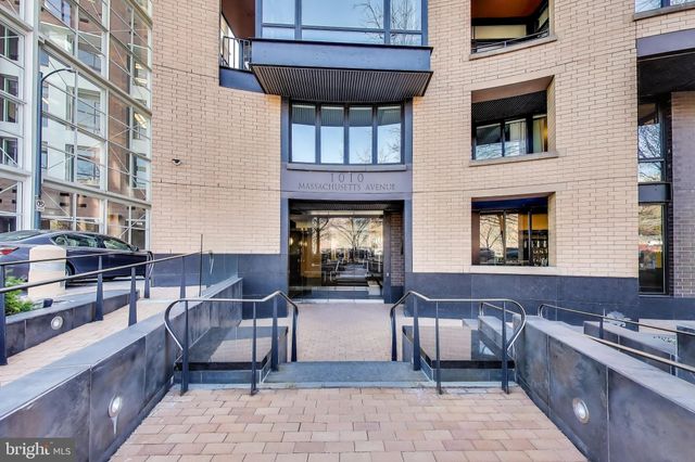 a view of a brick building and outdoor seating