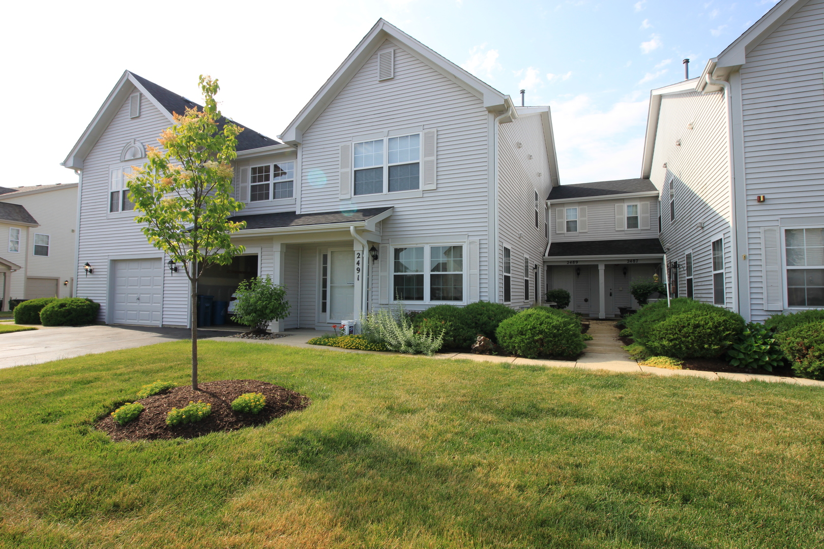 a view of a house with a yard and plants