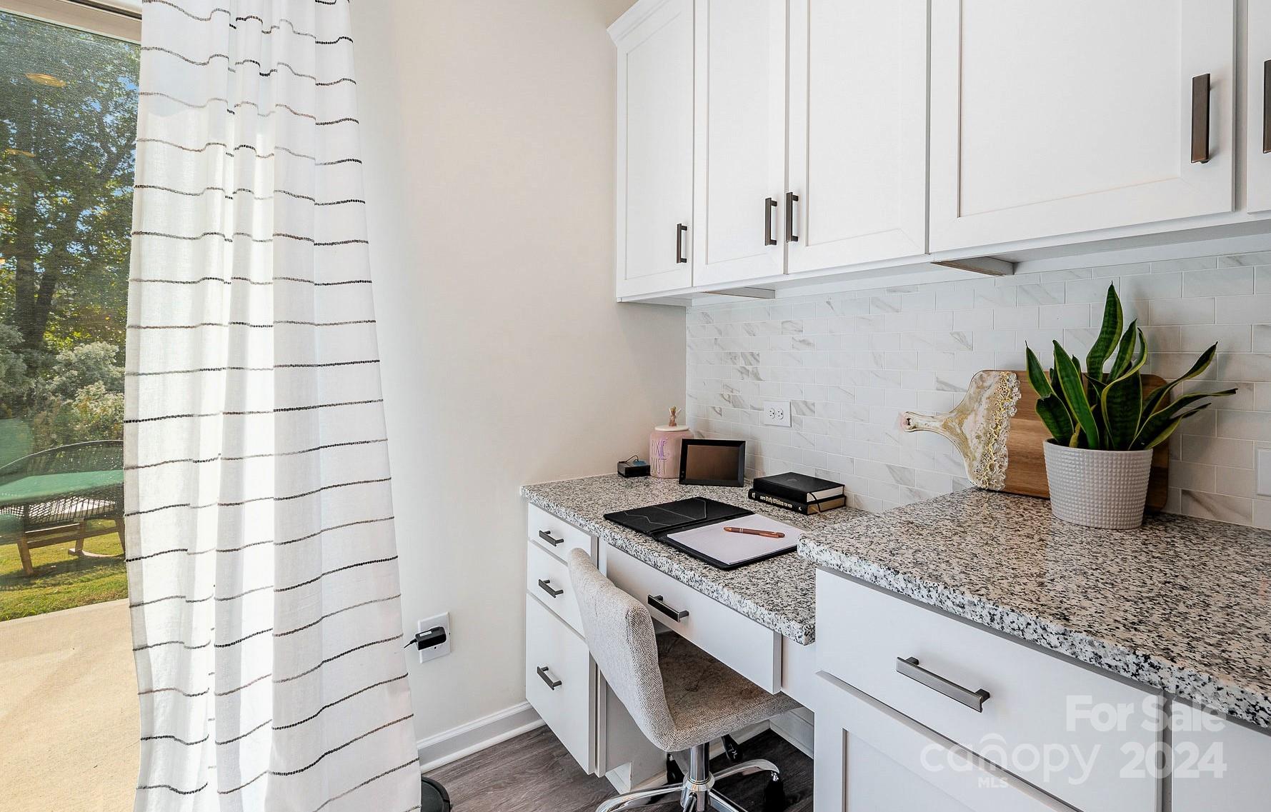 641 Amber Meadows Way Tega Cay, SC 29708 - Photo 13 of 28 a kitchen with granite countertop white cabinets and a potted plant
