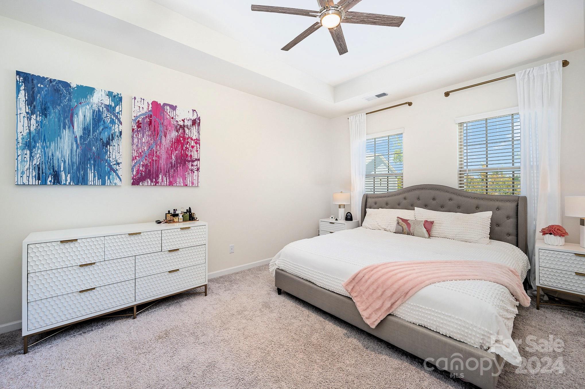 641 Amber Meadows Way Tega Cay, SC 29708 - Photo 15 of 28 a bedroom with a bed and a chandelier