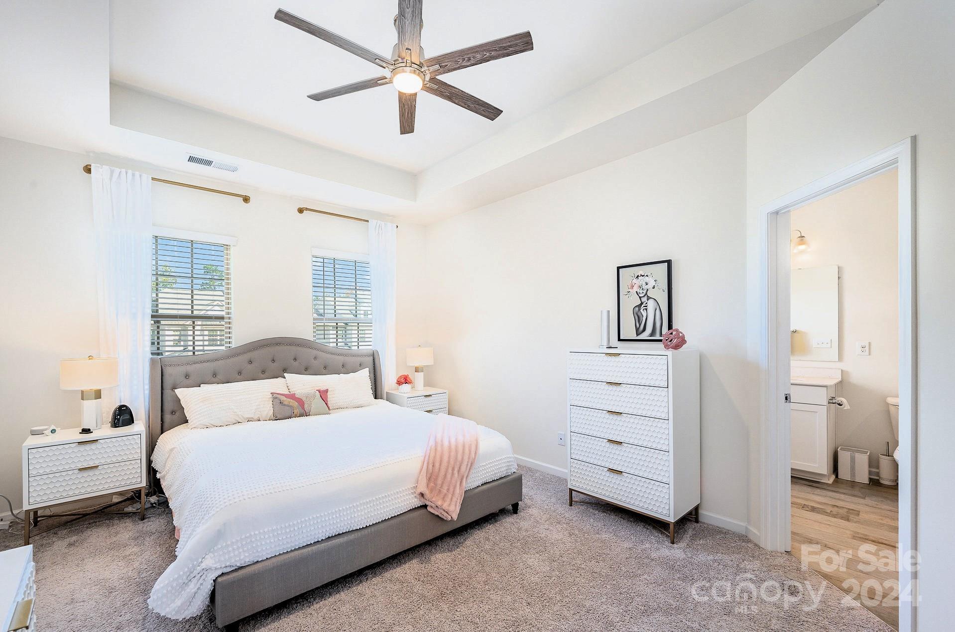 641 Amber Meadows Way Tega Cay, SC 29708 - Photo 16 of 28 a bedroom with a bed and a chandelier