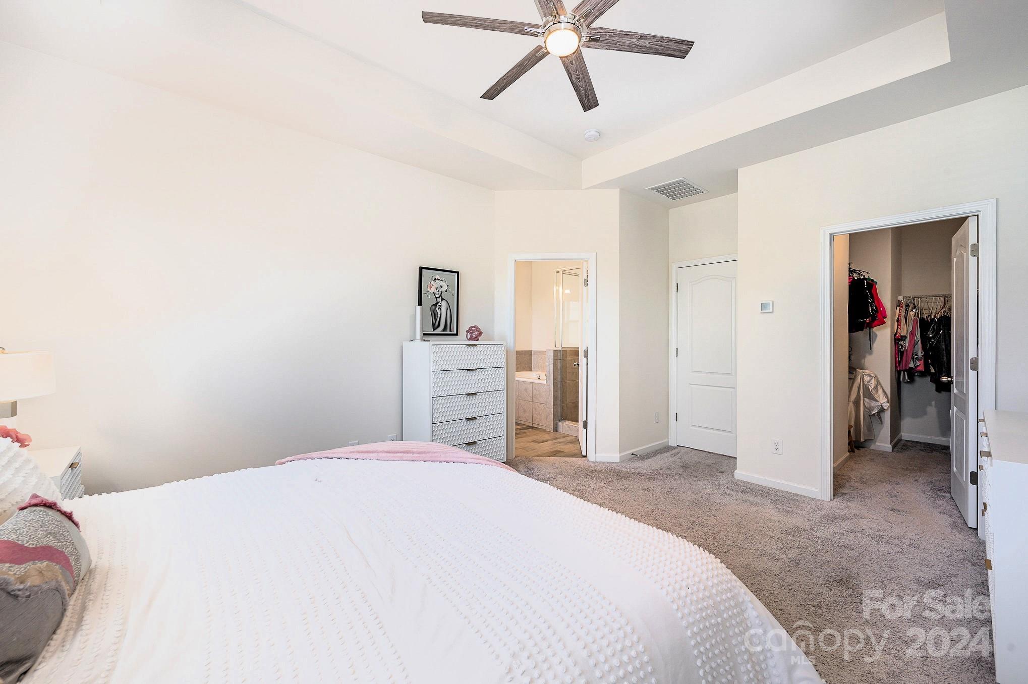 641 Amber Meadows Way Tega Cay, SC 29708 - Photo 17 of 28 a bedroom with a bed and a chandelier